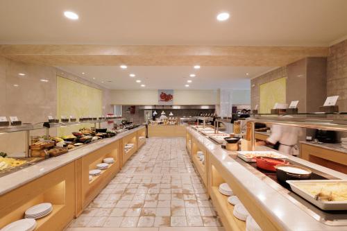 a large kitchen with lots of food on display at Mythos Panorama - Adults Only in Boukari