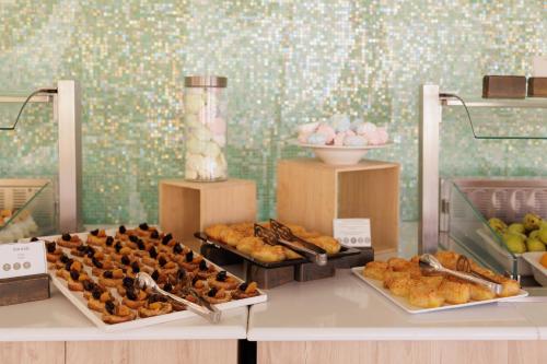 a buffet of pastries and other pastries on a table at Mythos Panorama - Adults Only in Boukari