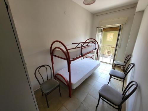 a room with two bunk beds and two chairs at The apartment on the Sea in San Leone