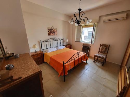 a bedroom with a bed and a table and a chair at The apartment on the Sea in San Leone