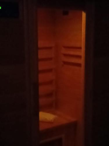 a dark room with a wooden cabinet and a table at Hotel La Fayette Giugliano Licola in Giugliano in Campania
