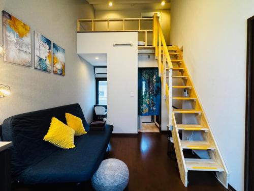 a living room with a couch and a loft bed at Lucky you! YOTSUYA in Tokyo