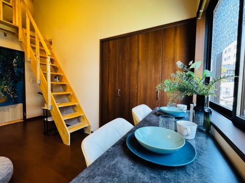 a dining room with a table with blue plates on it at Lucky you! YOTSUYA in Tokyo