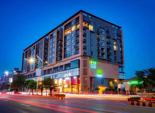a building on a city street at night at Sky Park Tower Premium Apartments Gulberg Greens Islamabad in Islamabad