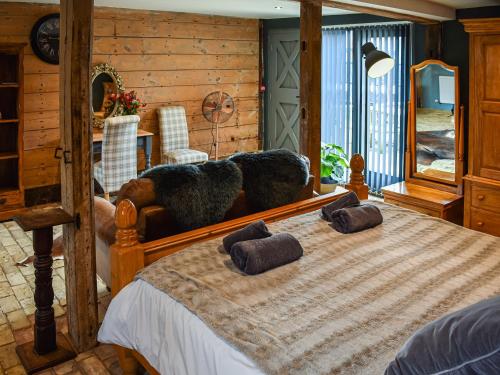 a bedroom with a bed with two stuffed animals on it at Highhouse Lodge in Bawdsey