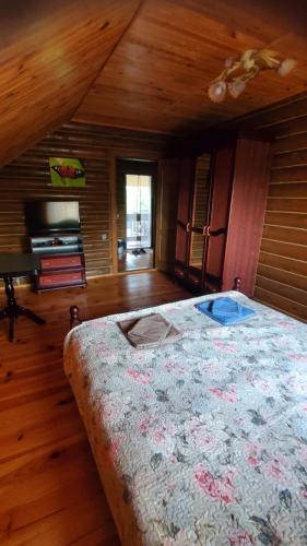 a bedroom with a bed and a wooden ceiling at Relax in Melʼniki