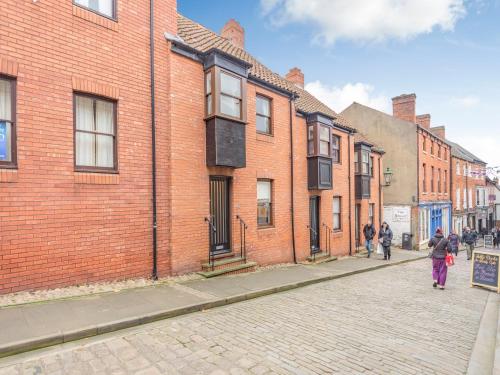 a woman walking down a street in a brick building at Victoria's Retreat - Uk41475 in Lincoln