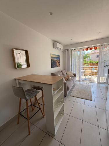 un salon avec un bureau et un canapé dans l'établissement Studio cosy avec piscine proche du bord de mer, à Villeneuve-Loubet