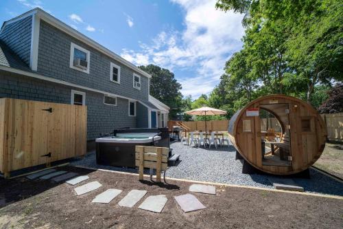 a backyard with a hot tub and a pool table at Family Yarmouth Beach Resort 3BR Getaway in Yarmouth