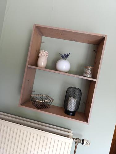 a shelf with vases and other items on it at Chez les Petits in Rochefort