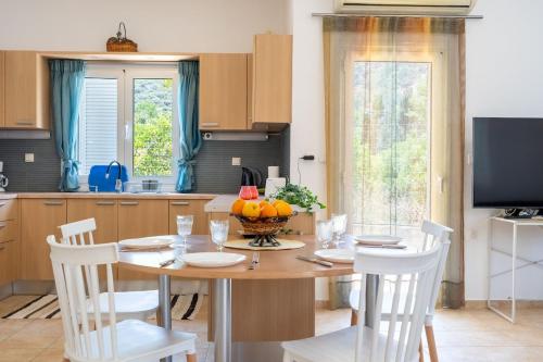 a kitchen with a table with a bowl of fruit on it at Citrus Garden Home in Fodele in Fodele