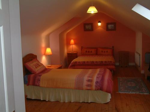 a bedroom with two beds in a attic at Seanor House Bed & Breakfast in Ballybunion