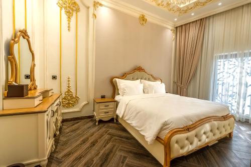 a bedroom with a large bed and a mirror at World Heart Residences in Baghdad