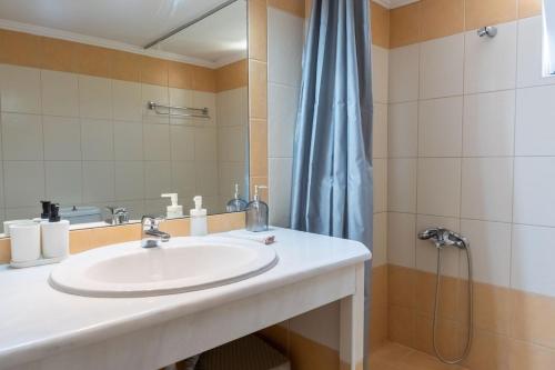 a bathroom with a sink and a shower at Citrus Garden Home in Fodele in Fodele