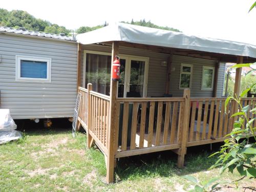a house with a deck with a fire hydrant on it at Emeraude aux 1000 Etangs in Belonchamp
