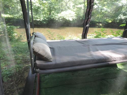 a bed in the back of a bus with a window at Emeraude aux 1000 Etangs in Belonchamp