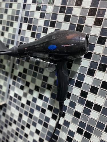 a black toothbrush on top of a tiled counter at The 21 Repoh Homestay in Kangar