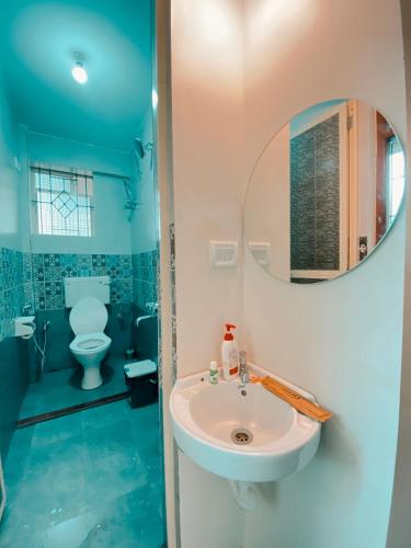 a bathroom with a sink and a toilet at GOAROUND - Neo Villas at Vagator by Goaround Homes in Vagator
