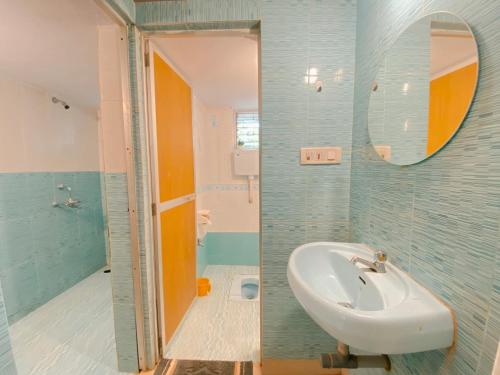 a bathroom with a sink and a mirror at GOAROUND - Neo Villas at Vagator by Goaround Homes in Vagator
