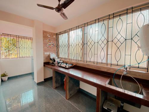 a room with a bench with stained glass windows at GOAROUND - Neo Villas at Vagator by Goaround Homes in Vagator