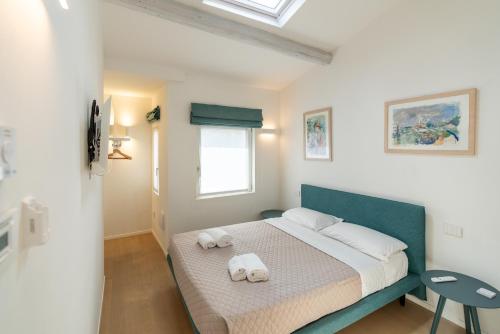 a bedroom with a bed with towels on it at Domus Verona - Dimora Capretto in Verona