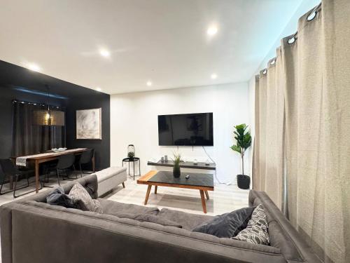 a living room with a couch and a table at Hollywood Black Habitat in Los Angeles