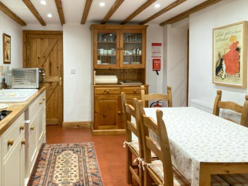 kuchnia i jadalnia ze stołem i krzesłami w obiekcie Woodhouse Cottage w mieście Hawarden