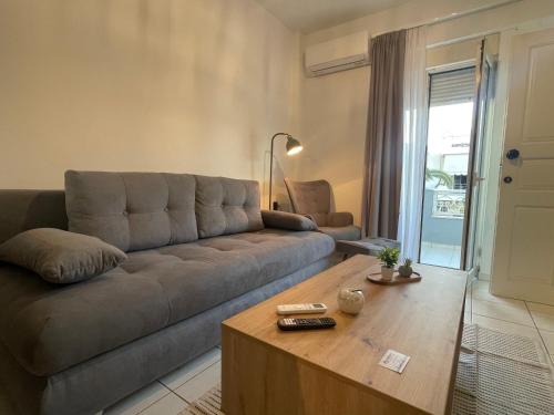 a living room with a couch and a coffee table at The Obsidian Suite , next to Heraklion Airport in Heraklion