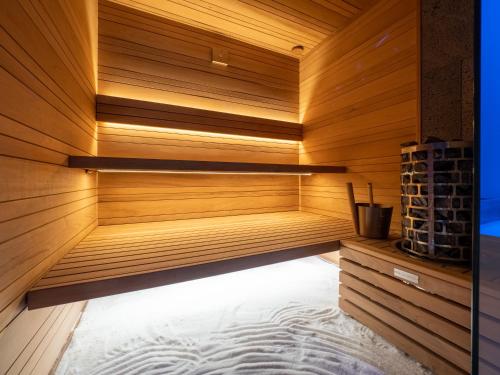 a sauna is shown with wooden walls and floors at vitamaris Wellness Apartment & Spa in Muggia