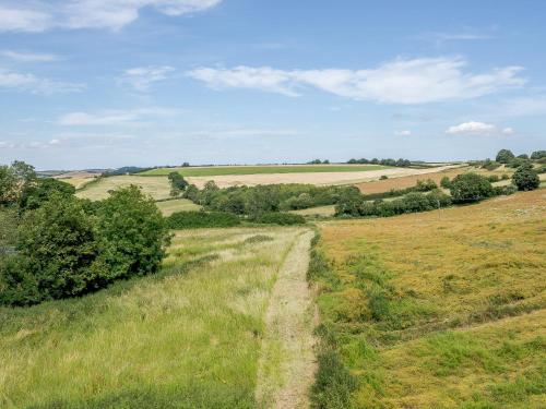 a dirt road in the middle of a field at The Chicken Coop in Fulletby