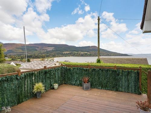 a balcony with a fence and a view of the water at Highview in Brodick