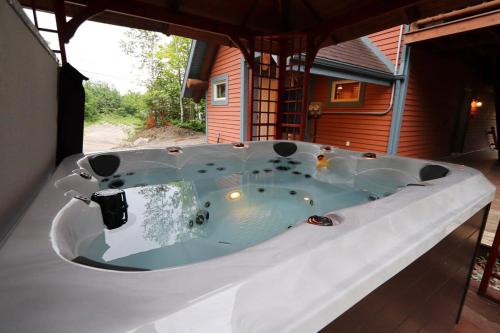 a large bath tub sitting in the middle of a house at Escapade parfaite - SPA Condo in Saint-Philémon