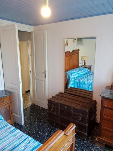 a bedroom with a bed and a large mirror at Casa Nonna Rina GE Liguria in Gattorna
