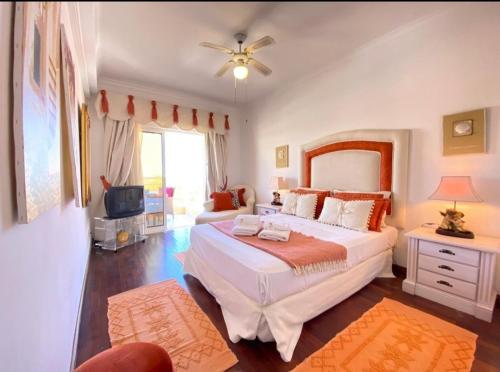 a bedroom with a large bed and a television at Vilamoura Central in Quarteira
