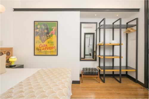 a bedroom with a bed and a poster on the wall at FAUNA Montevideo in Montevideo