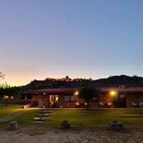 a house with a sunset in the background at Quinta do Nobre in Marialva