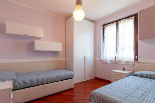 a bedroom with two beds and a window at AnnaLand in Padenghe sul Garda