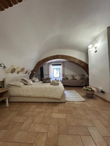 a bedroom with a large bed in a large room at La Residenza Del Vescovo in Stimigliano