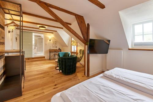 a bedroom with a bed and a flat screen tv at Rochter Landhotel in Zeltingen-Rachtig