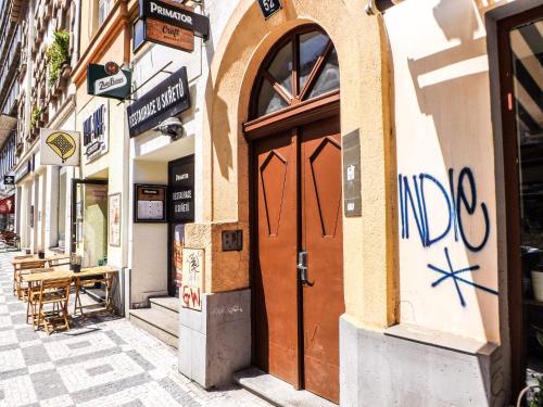 a door on a building with graffiti on it at Ubytování E4 Praha Letná in Prague