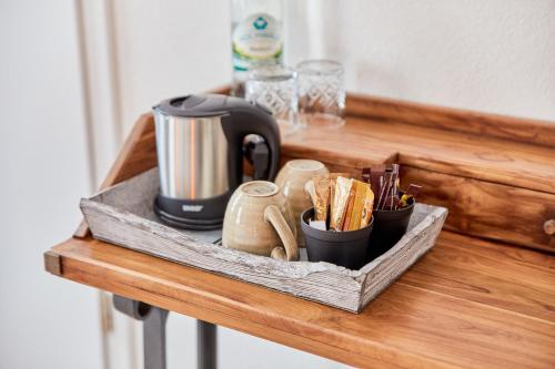 a wooden shelf with a coffee maker and cups on it at Rochter Landhotel in Zeltingen-Rachtig