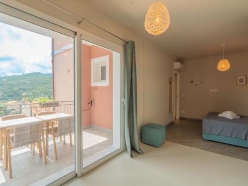 a room with a sliding glass door leading to a balcony at Appartamento Melograno "A Casa Felice" in Pietra Ligure