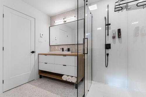 a bathroom with a sink and a glass shower at Serene Val Amico Spa Fireplace Lake Access in Sainte-Lucie-de-Doncaster