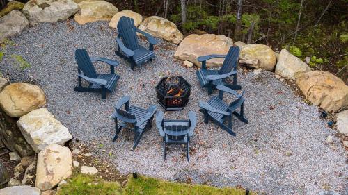 a group of chairs sitting around a fire pit at Serene Val Amico Spa Fireplace Lake Access in Sainte-Lucie-de-Doncaster