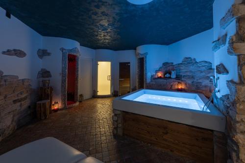 a large bathroom with a tub in a room at Flos Hotel in Moena
