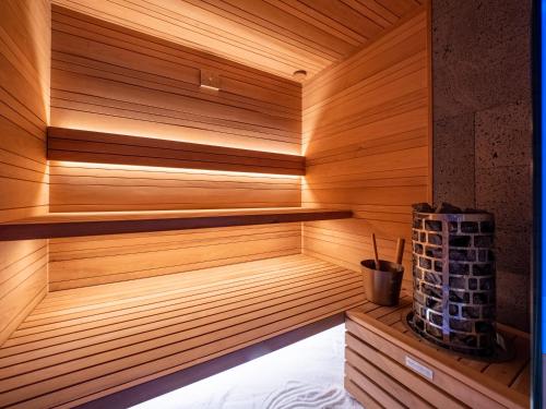 a sauna with wooden paneled walls and a wooden shelf at vitamaris Wellness Apartment & Spa in Muggia