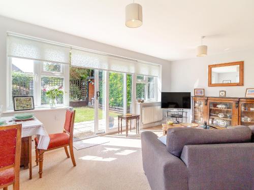 a living room with a couch and a table at Stella's Retreat in Loddon