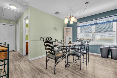 a dining room with a table and chairs at Game Room, Kayaks, Steps to the Ocean! in Ocean Gate