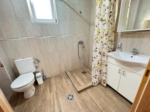 a bathroom with a toilet and a sink at Talia Apartments in Budva