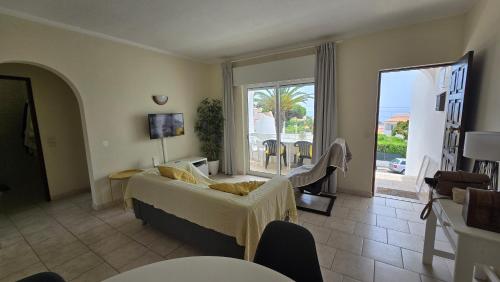 een woonkamer met een bank en een balkon bij Casa Vista Paraíso in Carvoeiro
